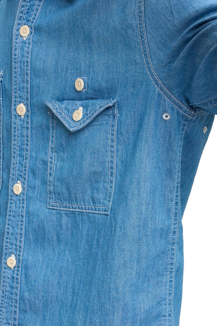 Close-up of a blue chambray shirt showing air vents in armpit, on a white background