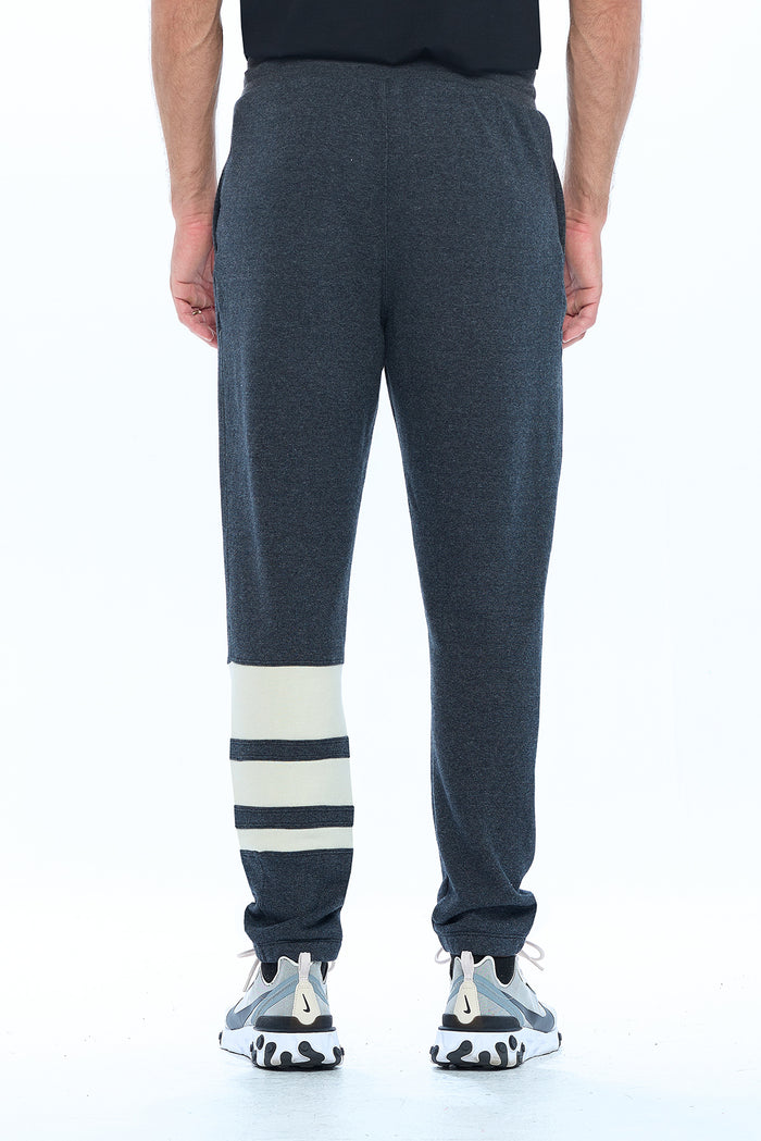 View from behind of the Aviator first class travel pants in grey color.
